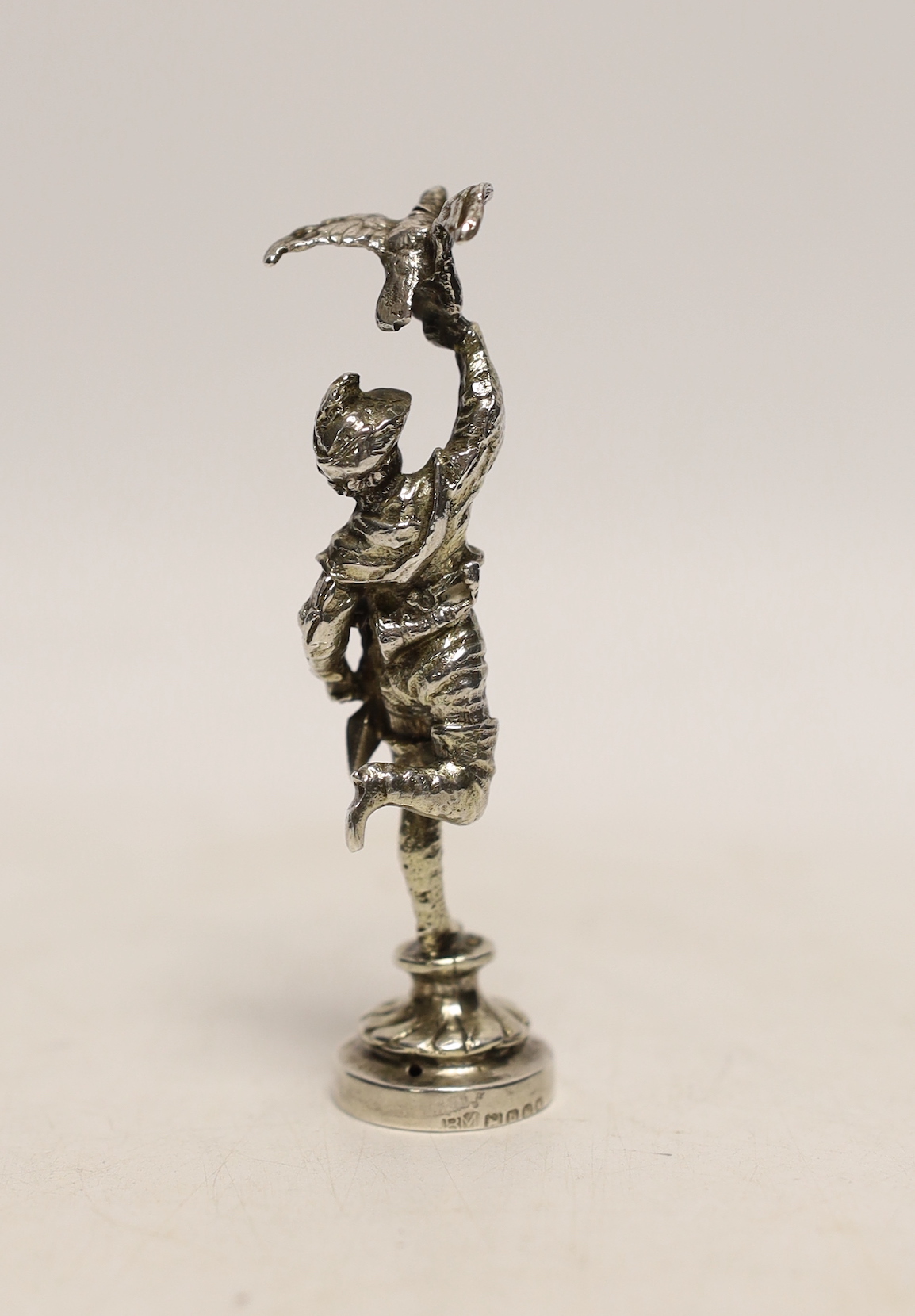 A late Victorian silver miniature model of a Falconer, on a circular base, import marks for Berthold Muller, London, 1897, 9cm.